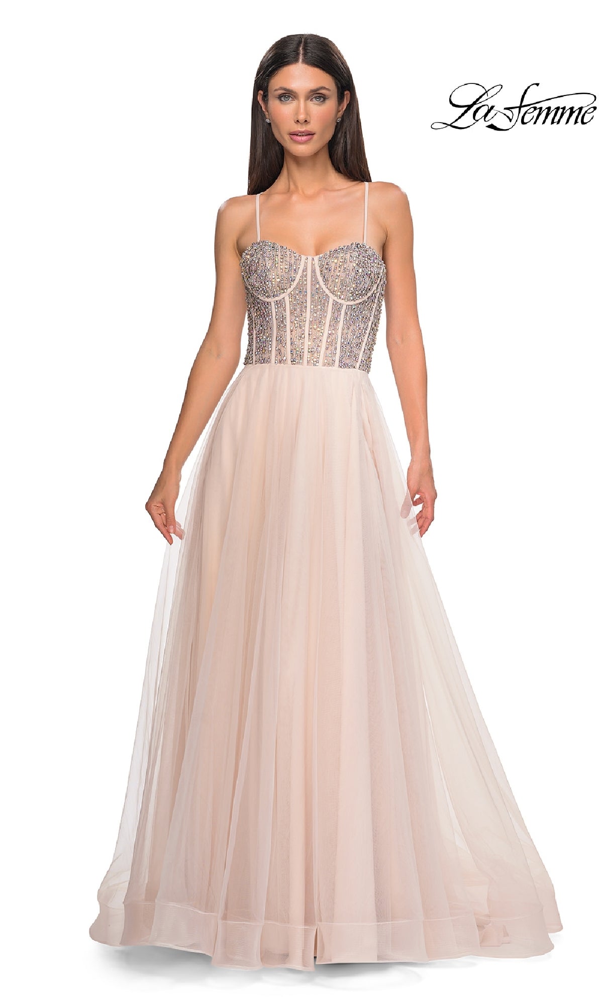 A woman models the La Femme 32703 Beaded-Corset Long Prom Dress—sleeveless, blush, with a fitted rhinestone-beaded corset bodice and sheer tulle skirt. The